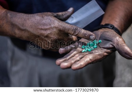 Uncut emeralds in the hand of a Colombian emerald miner in Muzo, Colombia. 