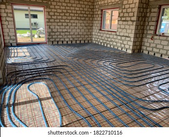 Undefloor Heating And Cooling Installation In House, Blue Pipes For Floor Heating At The House Construction, Warm Floor During The Winter