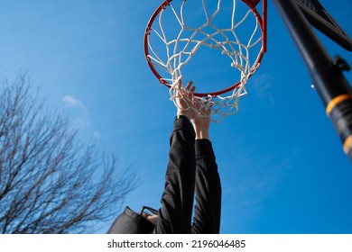 Under The Basketball Hoop With Child's Hands Reaching Up