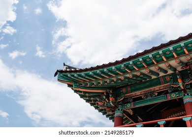 Under the blue sky, the eaves of a traditional building in Korea.