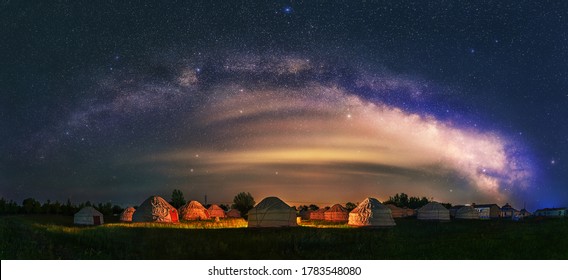 Under the bright Milky Way, Mongolia yurts on the grassland are scattered.	
 - Powered by Shutterstock