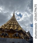 Under a bright sun, Bangkok’s colorful temples gleam with intricate mosaics and golden spires, their vibrant hues standing out against the clear blue sky.