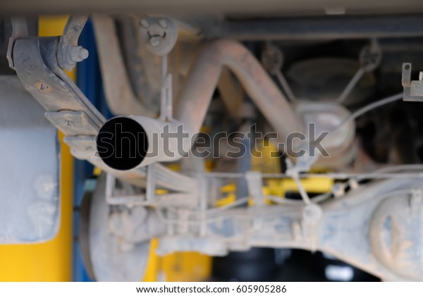 under car\
at auto service garage, maintenance the\
car