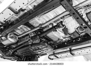 under the car chassis,truck drive shaft and exhaust chamber silencer muffler system - Shutterstock ID 2144438003