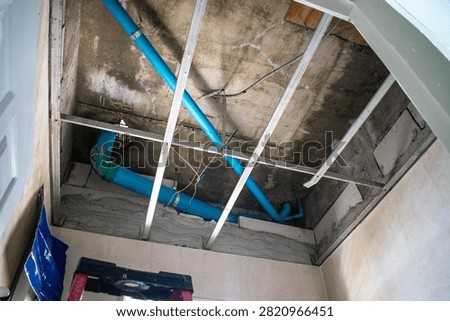 Under ceiling pipework for upper floor bathroom in house construction.