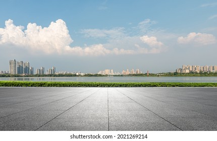 Under the clear sky, the city center buildings behind the stone square - Powered by Shutterstock