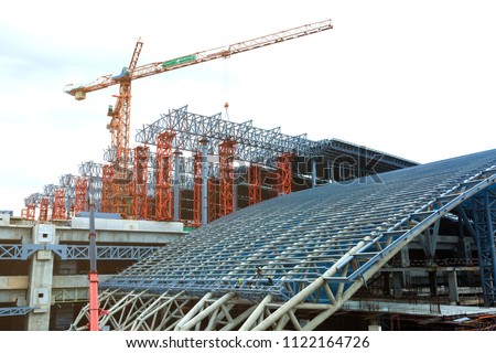 Under construction of metal steel framework outdoors buildings with crane.