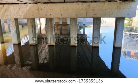 under a dutch bridge with waterreflection