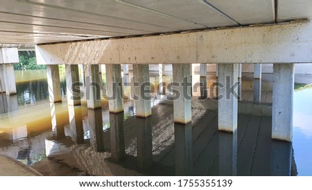 under a dutch bridge with waterreflection