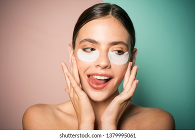Under eye patches for dark circles and puffiness. Taking care of her skin. Pretty woman using eye patches spending time at home. Daily pampering routine. Modern cosmetics. Eye patches concept. - Shutterstock ID 1379995061