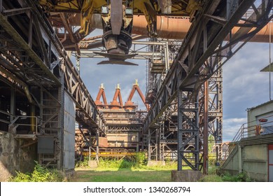 Under a giant electromagnetic crane in the blast furnace park of Uckange