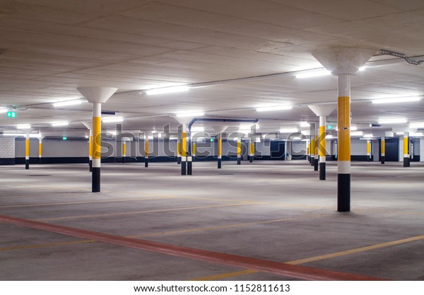 Under ground\
empty, illuminated car park\
floor