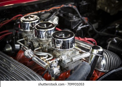 Under the Hood View of Restored Vintage Automobile Engine with Tri-Power Show-Chrome Carburetors

