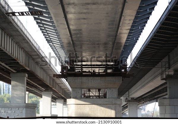 under a huge bridge
of concrete and steel