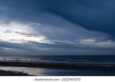 Under a moody sky, the last rays of winter sun cast a warm glow on the tranquil water, creating a stunning reflection that dances across the surface. - Powered by Shutterstock