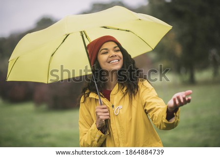 Similar – Image, Stock Photo Content woman under umbrella on beach in summer looking at camera