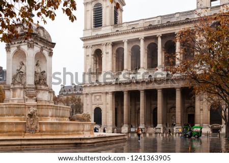 under rain , walking through the streets of Paris , place Sain Suplice