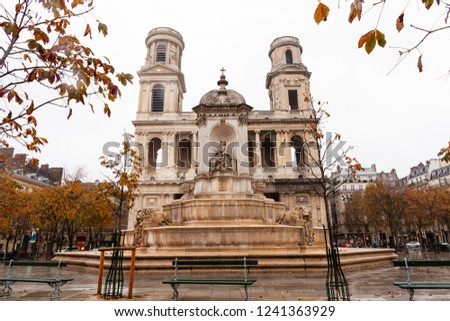 under rain , walking through the streets of Paris , place Sain Suplice