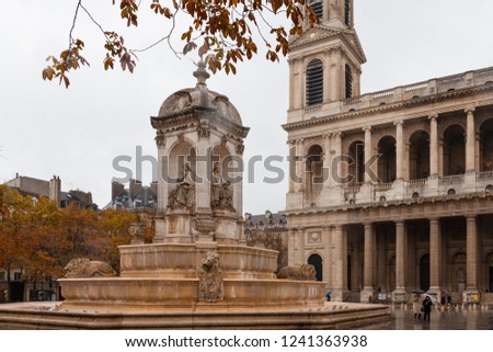 under rain , walking through the streets of Paris , place Sain Suplice