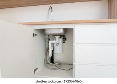 Under A Sink In A Modern Kitchen There Is A Hot Water Heater