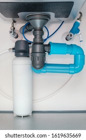 under sink plumbing   drainage system  water purification system install under modern kitchen sink  shallow depth field