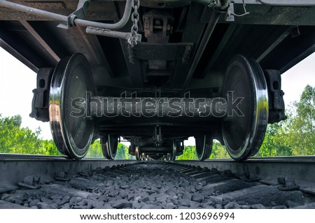 Under the train. Super wide angle, perspective lines. Railway background. Freight train, railroad theme. Transporting system, cargo service. Set of wheels. High speed train. Travel and adventures