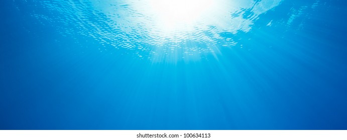 under water, abstract panorama of sun rays in the ocean