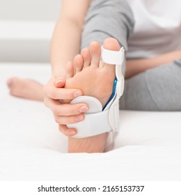 under the woman's foot with orthosis.    The solution to treat and help with painful bunions and Hallux Valgus on big toe