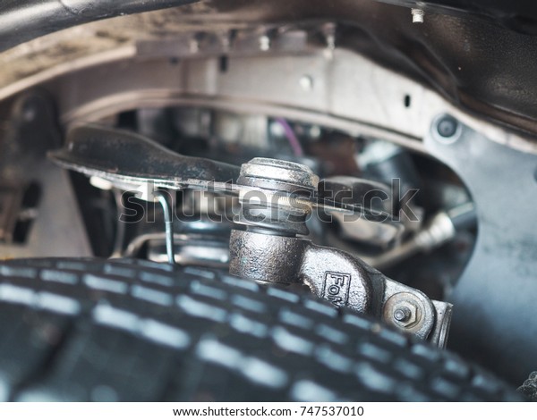 undercarriage of a car in garage. vehicle\
maintenance in auto repair service shop. automobile annual checkup.\
fixing, checking\
concept