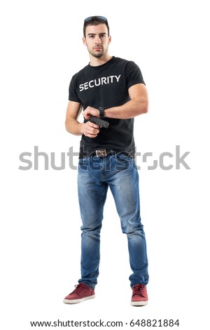 Undercover policeman in plain clothes cocking gun looking at camera.  Full body length  portrait isolated on white studio background.