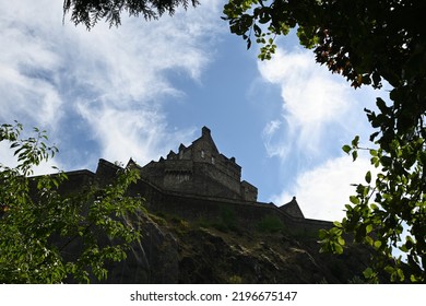 Underexposed Shot Of Castle Rock And Castle In Centre Of Edinburgh, Scotland Viewed From Below 