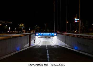 Underground Car Park Entrance With German Inscriptions In Luzern. Night View, Illuminated By Lights. Street Signs On The Ground. Nobody Inside 