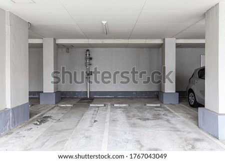Underground car parking lot. Indoor parking area. Concrete basement floor parking garage