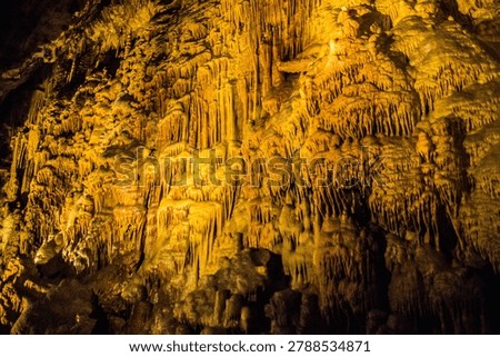 Underground cave with unique rock formations and warm lighting during