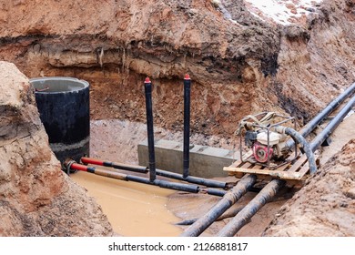 Underground Communications. Heating Pipes In A Trench Flooded With Water. Pipes Were Laid In The Excavated Trench. Pipeline Accident. Pumping Water From A Trench