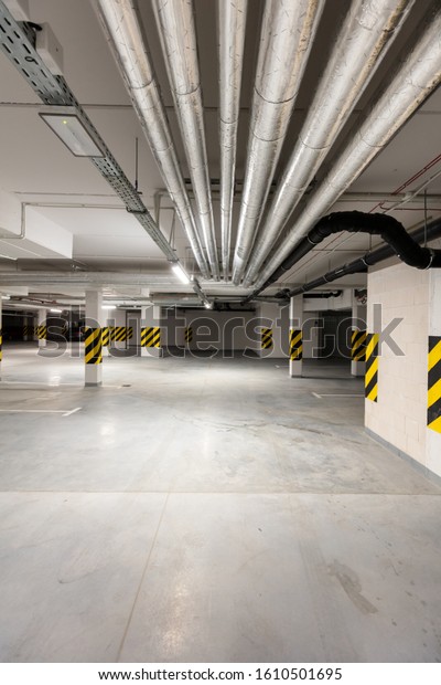 Underground empty parking garage. Modern urban\
space. Wide angle