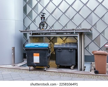 Underground garbage Bin Storage elevator lifting a parked bicycle - Shutterstock ID 2258106491