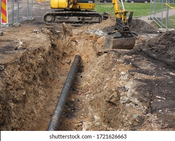 Underground Gas Line On The City. Consruction Site. CRAWLER EXCAVATOR Works On Digging The Trench 