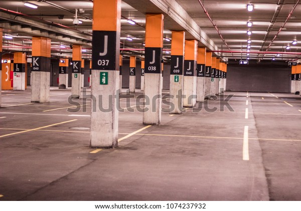 Underground large parking- Large car parking found\
on the ground floor of a shopping center. The parking lot is very\
bright and safe, but it is\
empty.
