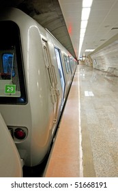 Underground metro station with a train at the platform