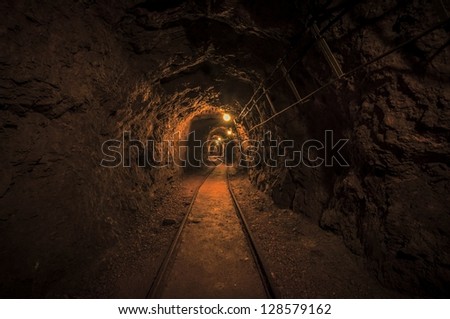 Underground mine passage with rails and light