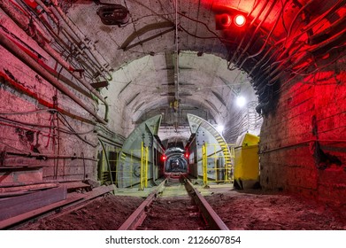 Underground mine. Underground railway for transporting ore. Mine trolley as part of an underground freight train