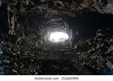 Underground mining, tunnel in the rock. There is a bright light at the end of the tunnel - Shutterstock ID 2126607890