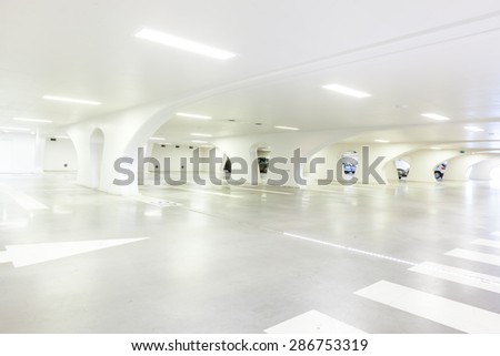 Underground park of a mall with columns and ventilation ducts