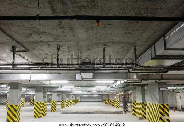 Underground parking. Basement garage concrete\
interior. Underground parking interior. Parking garage and\
underground lot. Parking without\
cars
