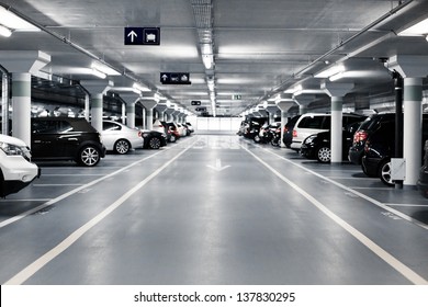 Underground parking with cars. White colors.