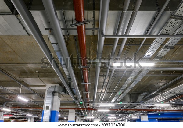 Underground\
parking of a commercial building. Air ducts of the air conditioning\
and ventilation system, pipes of the fire extinguishing system,\
electric cable channels under the\
ceiling.