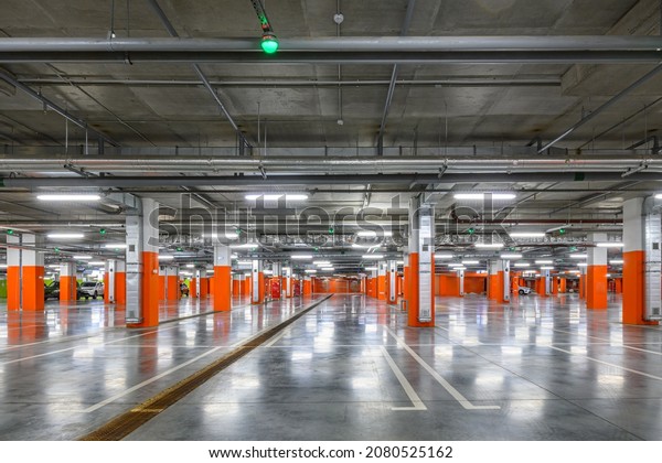 Underground parking of a commercial building\
with navigation system sensors. Air conditioning and ventilation\
ducts, fire extinguishing system pipes, electric cable channels\
under the ceiling.