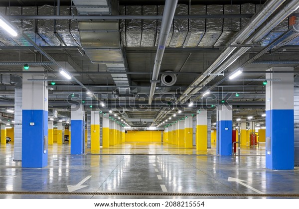 Underground parking of a commercial building\
with navigation system sensors. Air conditioning and ventilation\
ducts, fire extinguishing system pipes, electric cable channels\
under the ceiling.