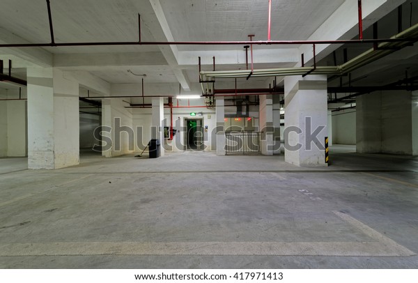 Underground parking lot. Basement parking. Car park\
spaces. Empty parking.\
